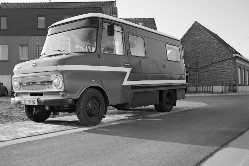 Classic Opel van parked on street, showcasing retro automotive design in monochrome.