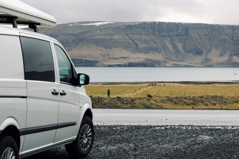 Explore the beauty of Iceland on a road trip with this captivating lake view and camper van.