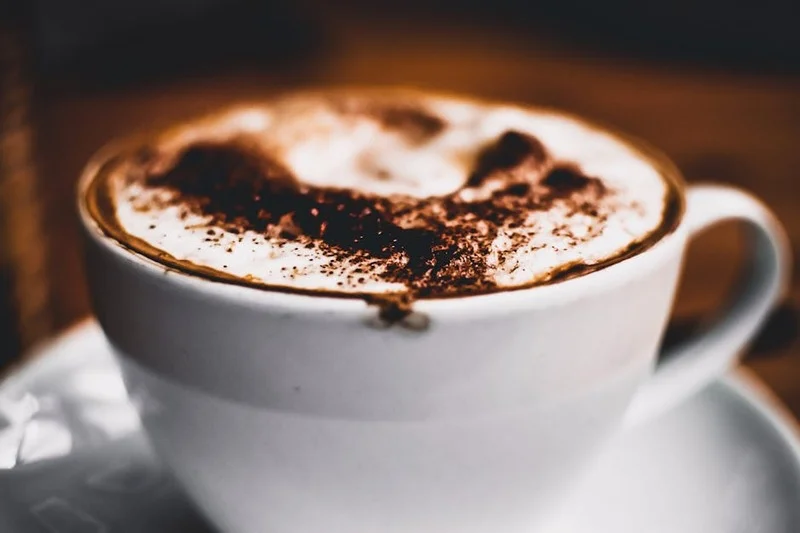 Rich dark hot chocolate with whipped cream in a cafe
