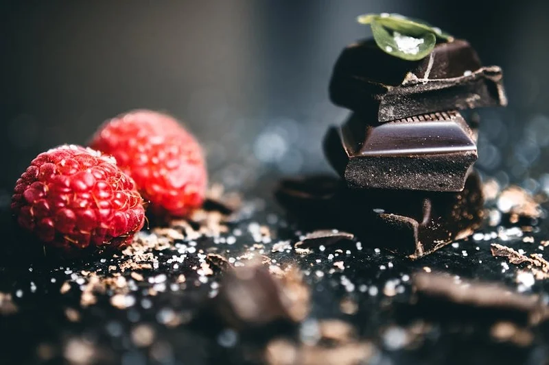 Rich vegan chocolate avocado tart topped with fresh berries