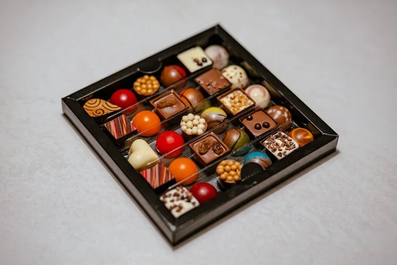 Artisanal chocolate bonbons with sea salt caramel and raspberry
