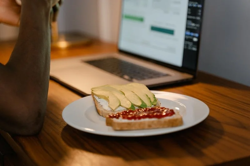 Minimalist workspace with filter coffee and avocado toast