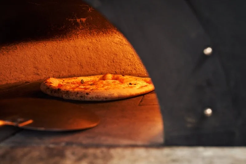 Authentic pizza preparation at Bella Napoli