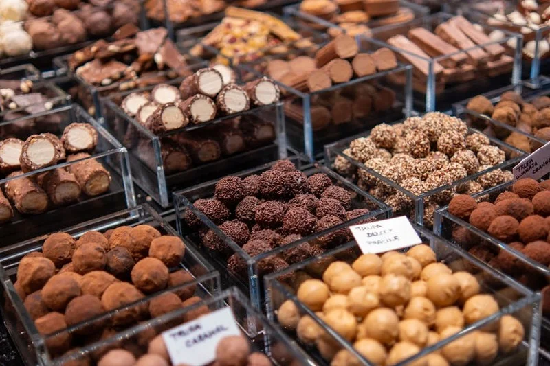 Beautifully crafted chocolate truffles and pralines in a display case