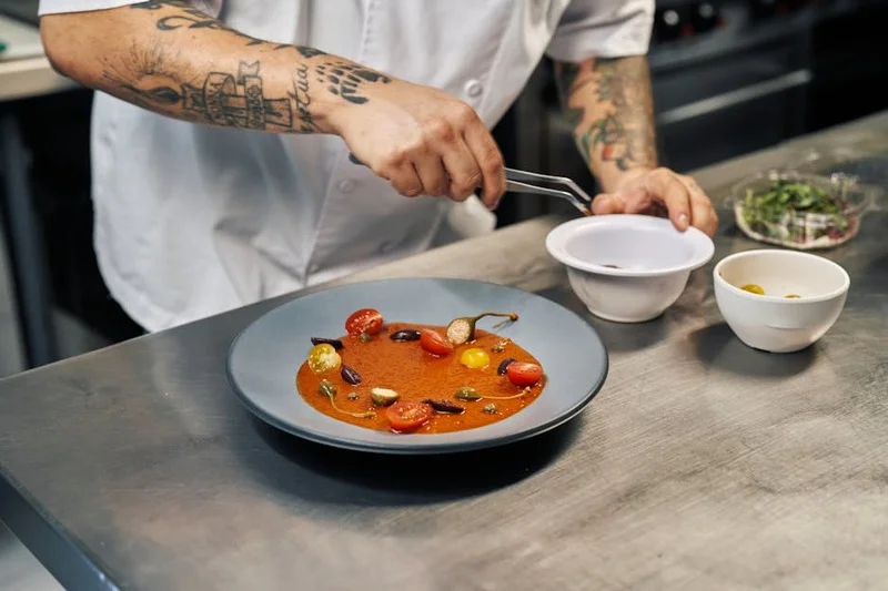 Chef plating a complex dessert